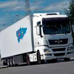 Camión blanco con remolque blanco en carretera